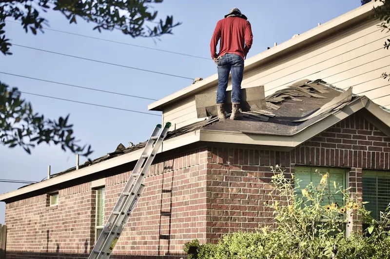 Professional roofer working on a residential roof in Weymouth Landing